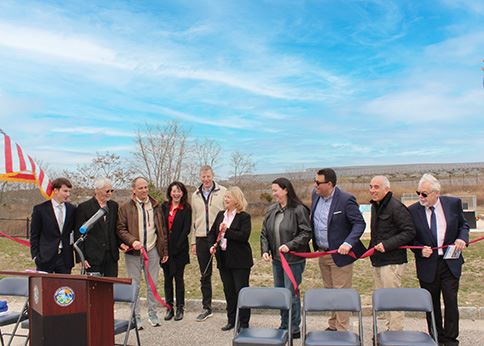 Officials cutting the ribbon at the Solar Array Ribbon Cutting event, March 2025